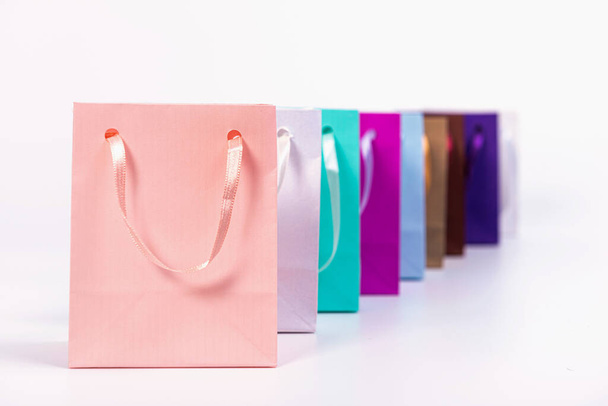 many colourful paper shopping bags isolated on white background, mockup for design - Φωτογραφία, εικόνα