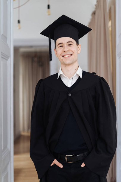 Caucasian young man feeling very excited to receive his bachelors degree - Fotó, kép