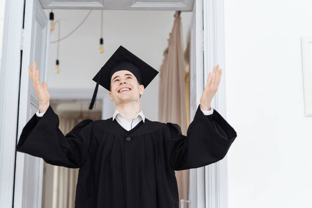 Caucasian young man feeling very excited to receive his bachelors degree - Photo, Image