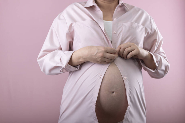 woman with hands on her  belly. big pregnant belly - Photo, Image