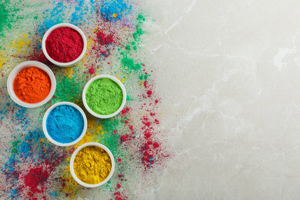 Colorful powder dyes on light marble background, flat lay with space for text. Holi festival - Valokuva, kuva