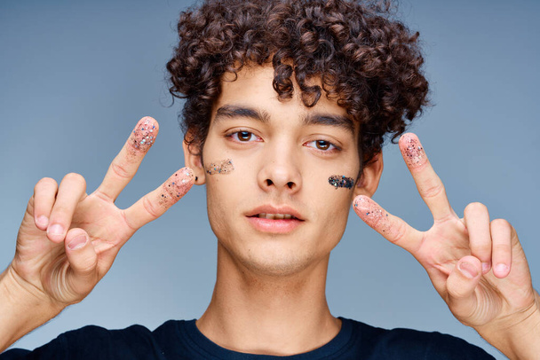 handsome man with curly hair black cosmetics hand gesture - Photo, Image