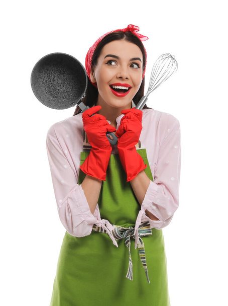 Young housewife with saucepan and whisk on white background - 写真・画像