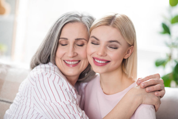 Photo of attractive happy nice family mother and young woman smile hug cheeks smile indoors inside house - Fotografie, Obrázek