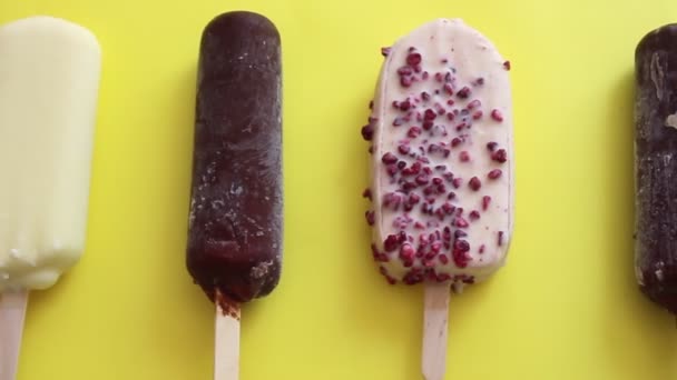 Ice lolly. Various ice cream on a yellow background. View from above. - Footage, Video