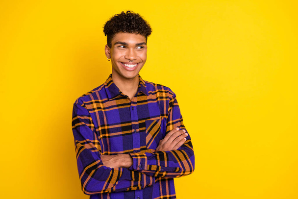 Photo portrait of young man smiling folded hands looking empty space isolated vivid yellow color background - Foto, Imagem