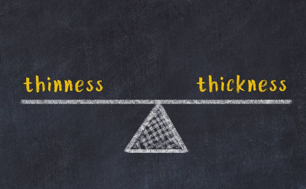 Concept of balance between thinness and thickness. Black chalboard with sketch of scales and words on it - Foto, afbeelding
