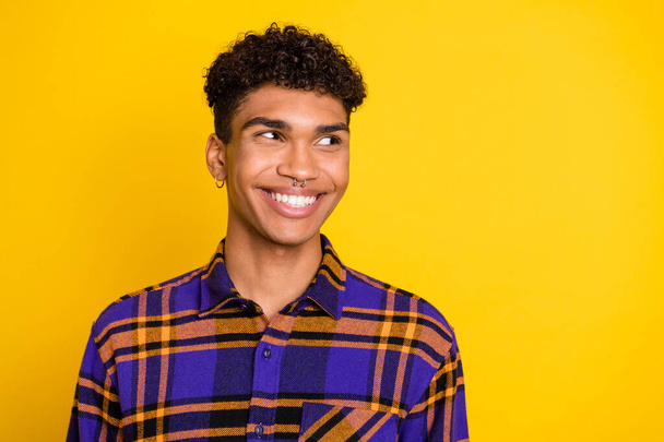 Photo portrait of handsome guy wearing plaid outfit looking empty space isolated on vibrant yellow color background - Fotografie, Obrázek