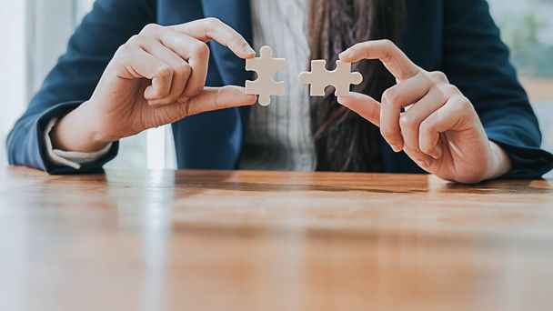 Business man hands connecting jigsaw puzzle. Business solutions, success and strategy concept. - Photo, Image
