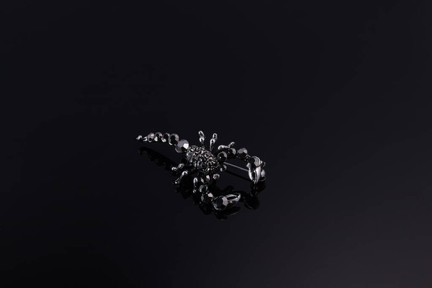 Bijouterie and jewelry on a dark background. Brooches and hairpins earrings and pendants. Copy space - Photo, Image