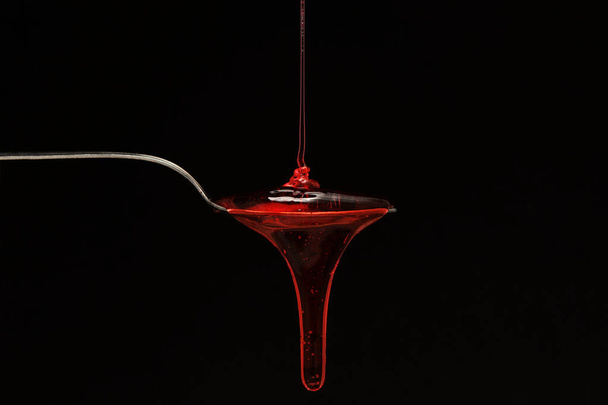 syrup spilling into a spoon - Photo, Image
