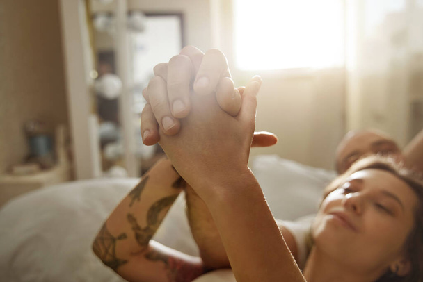 Couple in love holding hands of each other while spending their morning - Photo, Image