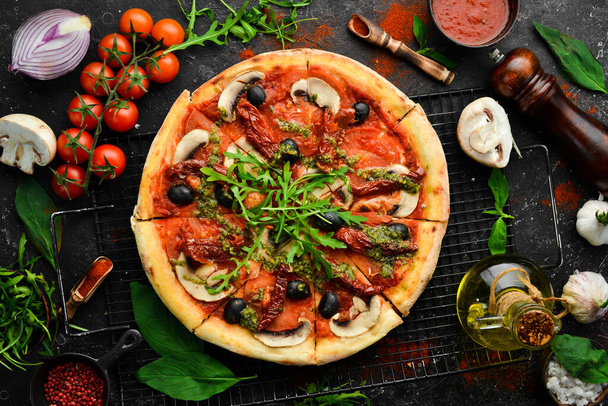 Homemade pizza with sun-dried tomatoes, mushrooms and olives. Italian cuisine. Food delivery. - Zdjęcie, obraz