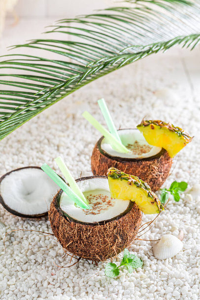 Drink for summer heat. Tropical pinacolada in coconut in sunny day.  - Valokuva, kuva