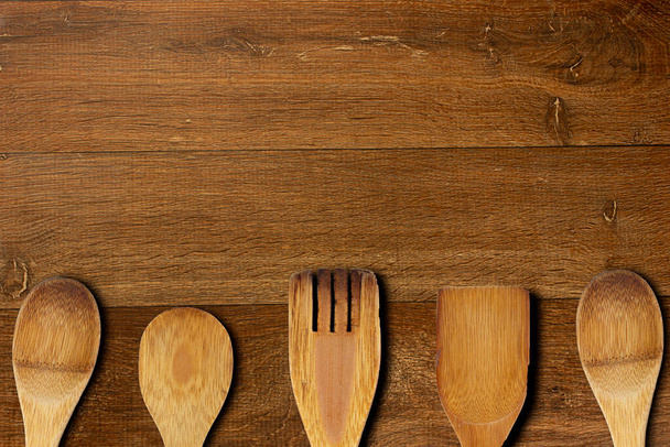 Topview of a rustic wooden table with wooden spoon and fork - Photo, Image