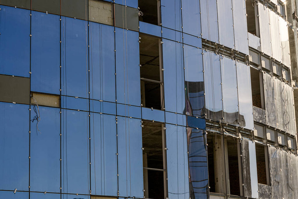 Εγκατάσταση γυάλινης πρόσοψης σε πολυώροφο κτίριο. Κατασκευή και συντήρηση κτιρίων - Φωτογραφία, εικόνα