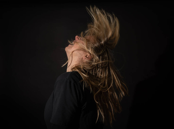 Hair blown away with head movement - Foto, afbeelding