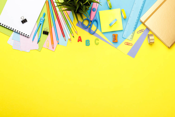 Back to school concept. Colorful stationary school supplies on yellow  background, space or text flat lay - Photo, Image