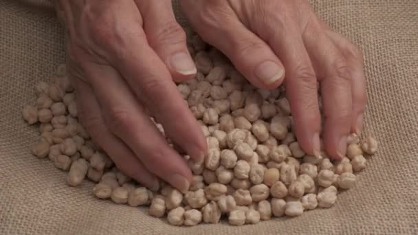 Dry chickpeas hand giving, Mediterranean food organic agriculture - Materiał filmowy, wideo
