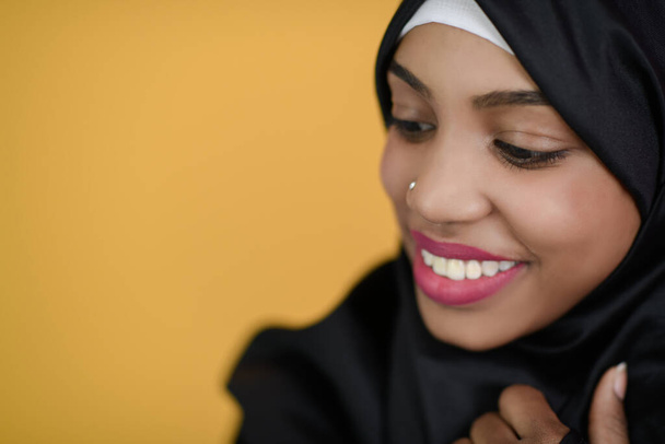 african muslim woman with a beautiful smile takes a selfie with a cell phone - Fotografie, Obrázek