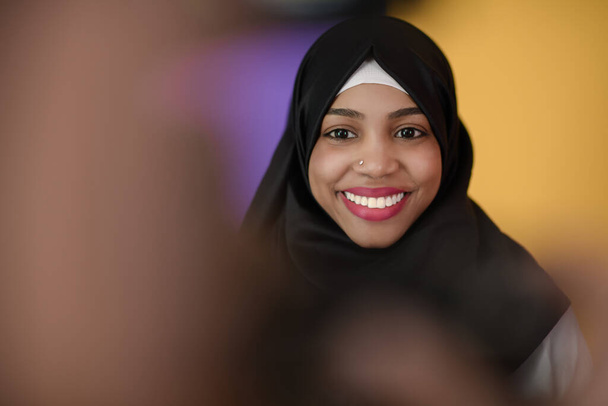 muslim woman with a beautiful smile wearing a hijab poses in the studio - Фото, зображення