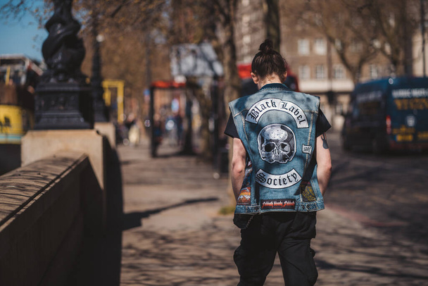 Westminster, London | UK -  2021.04.17: Man in jeans west with Black Label Society sign walking down the emankment - 写真・画像