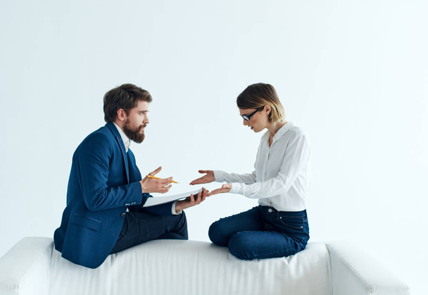Woman and man are sitting on the couch in suits documents psychology staff - Photo, image