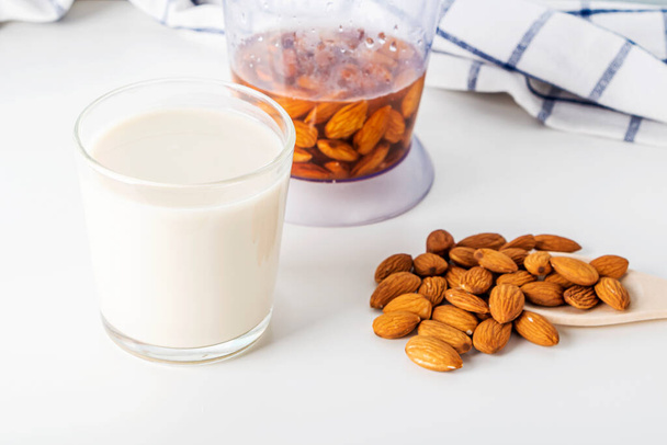 Step by step recipe. Cooking nuts vegetable milk. Step 3 cooked  almonds milk in glass. Homemade food concept. Plant based organic veggie milk, lactose free.  - Foto, Imagem