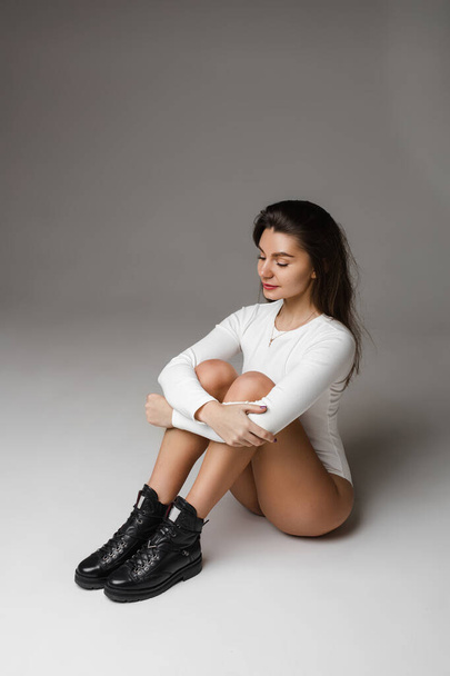 Slender model in white body and black boots. - Photo, Image