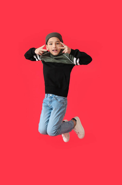 Jumping little boy on color background - 写真・画像