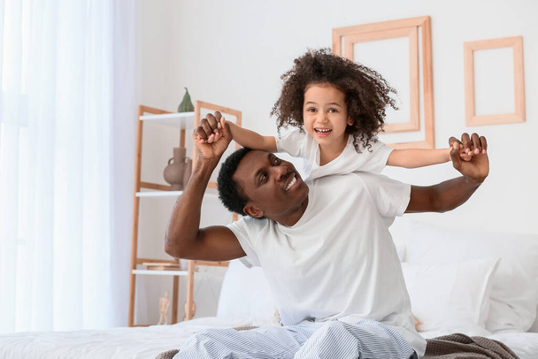 Portrait of happy African-American father and his little daughter at home - Photo, Image