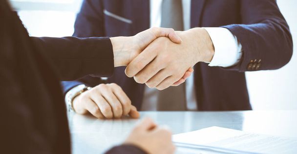 Business people or lawyers shaking hands finishing up a meeting, close-up. Negotiation and handshake concepts - Photo, Image