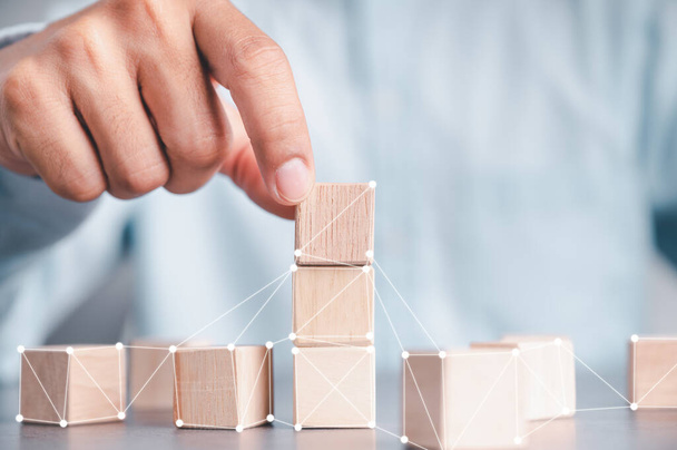 An arrangement of wooden blocks with interconnected networks. Service business ideas for success Planning business strategies for victory in the market. - Fotoğraf, Görsel
