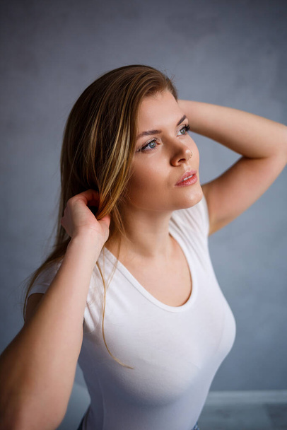 Close up portrait of a beautiful young woman. Emotional photo of a girl. Dressed in a white t-shirt - Fotografie, Obrázek