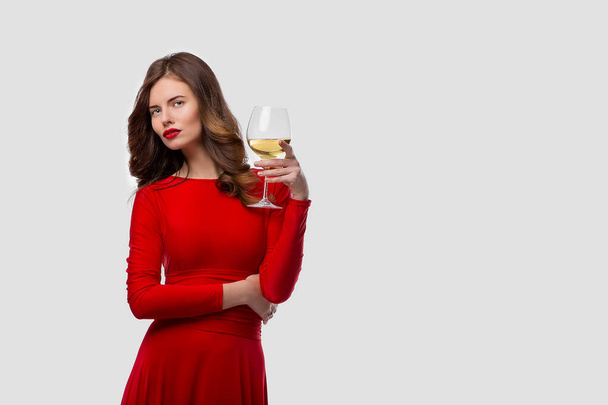 Beautiful woman holding glass of wine onwhite background - Zdjęcie, obraz