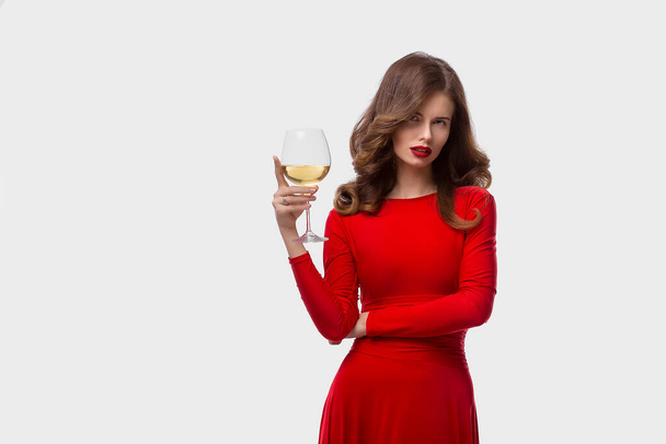 Beautiful woman holding glass of wine onwhite background - Photo, Image