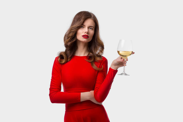 Beautiful woman holding glass of wine onwhite background - Fotó, kép