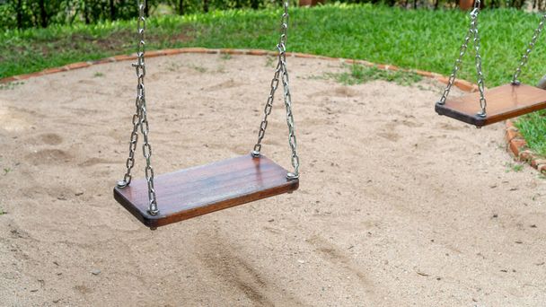 Close up of wooden swing in a playground. - Photo, Image