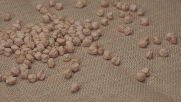 Dry chickpeas legumes rotating on jute - Materiał filmowy, wideo