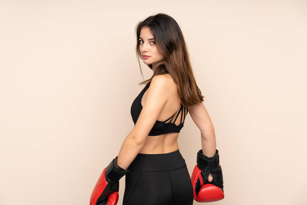 Young sport woman with boxing gloves over isolated background - Fotoğraf, Görsel