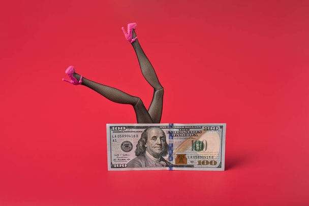 Sexy woman legs in black fishnet stockings over dollar bill, Sex for money concept. - Photo, Image