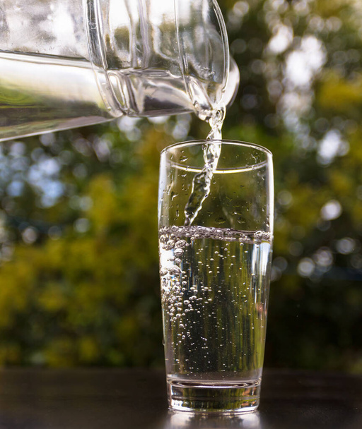A closeup shot of water pouring into a glass - 写真・画像