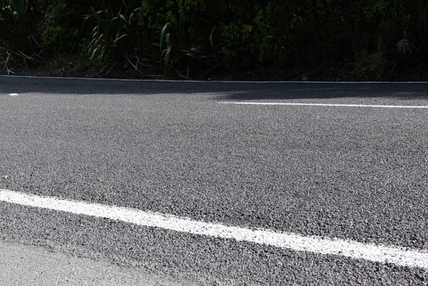 View of rural asphalt road with coarse aggregate - Фото, изображение