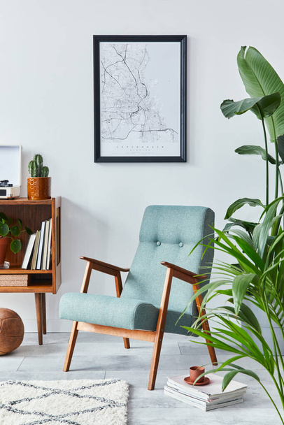 Stylish interior of living room with design wooden shelf, retro armchair, plants, mock up poster map, decoration, book, cacti and personal accessories in retro home decor. Template. - Fotoğraf, Görsel