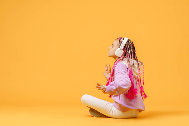 Back view of Adorable child in rounded glasses with pink dreadlo - Fotografie, Obrázek
