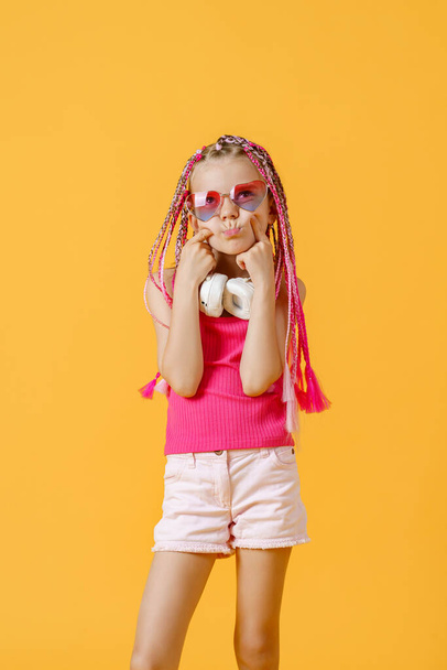 Crazy expressive trendy DJ girl in bright clothes, headphones an - Фото, зображення