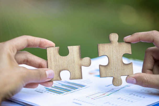 Two hands of businessman to connect couple puzzle piece. symbol of association and connection. business strategy. - Photo, Image