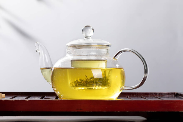 A closeup of a teapot on the tray - Photo, Image