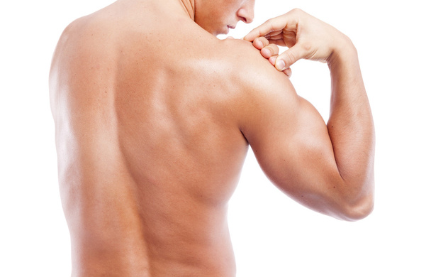 Muscular man holding his shoulder - Fotografie, Obrázek