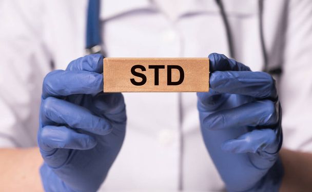 STD acronym, word. Medical disease in doctor hands - 写真・画像